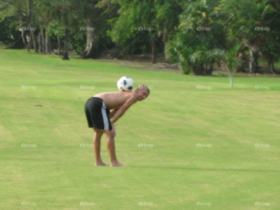 Soccer ball balanced on back 