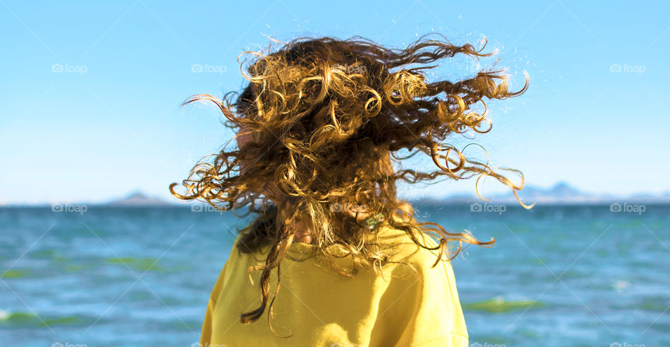 Blonde woman at the beach shaking head