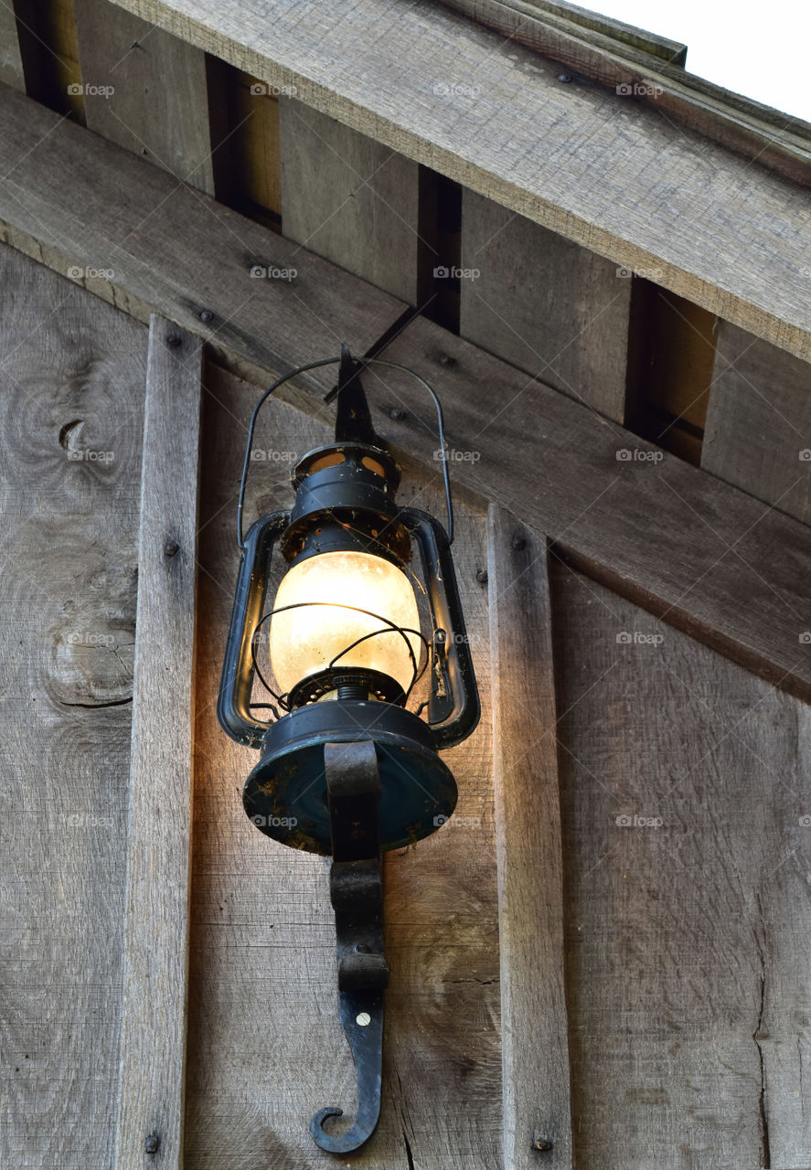 Antique lantern hanging in a roof peak