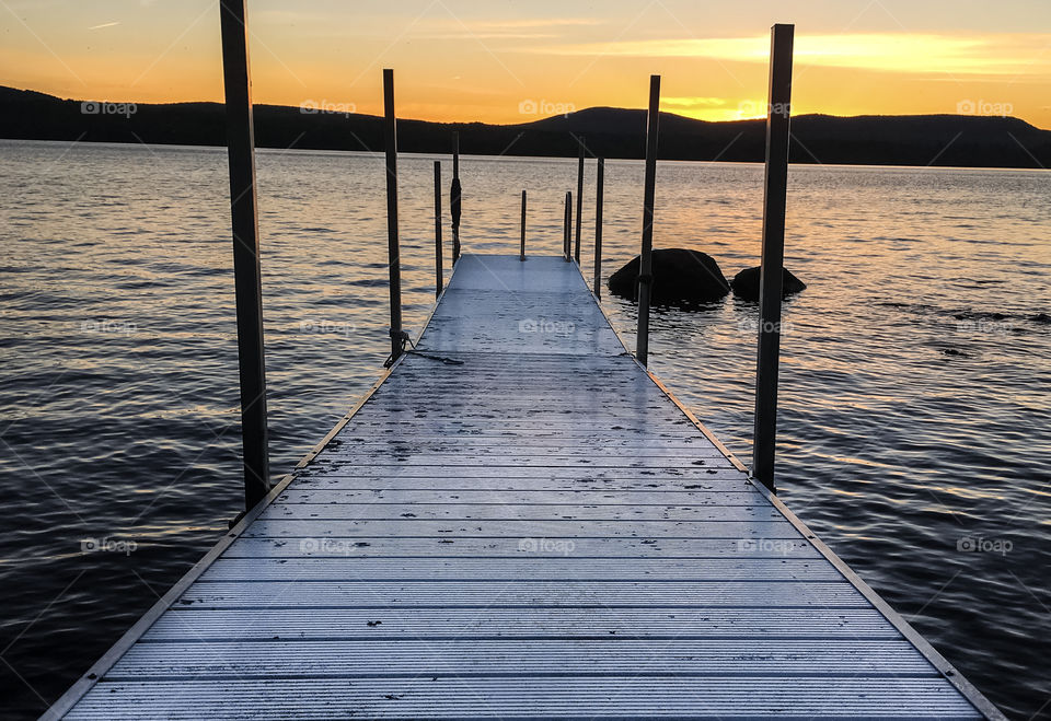 Dock on the lake at sunset perspective 