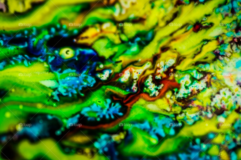The ink to refill the printer cartridge was spilled onto the white washbasin and the paints blended into abstract drips and patterns.