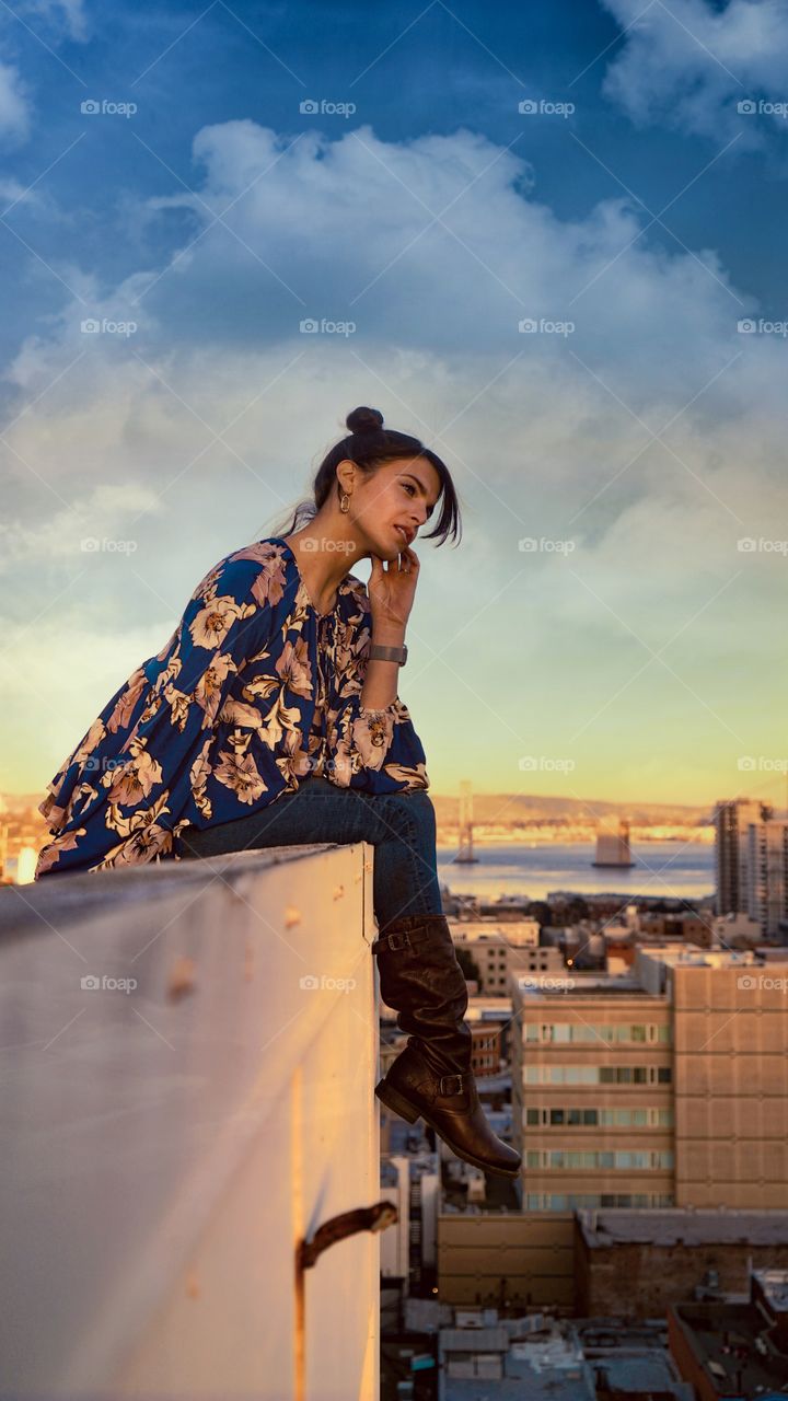 A girl on a ledge just thinking about life... the San Francisco bay bridge in the background. A lot on her mind, she normally does nudes but I had her put some clothes on for this particular photo. Sort of funny if you think about it.