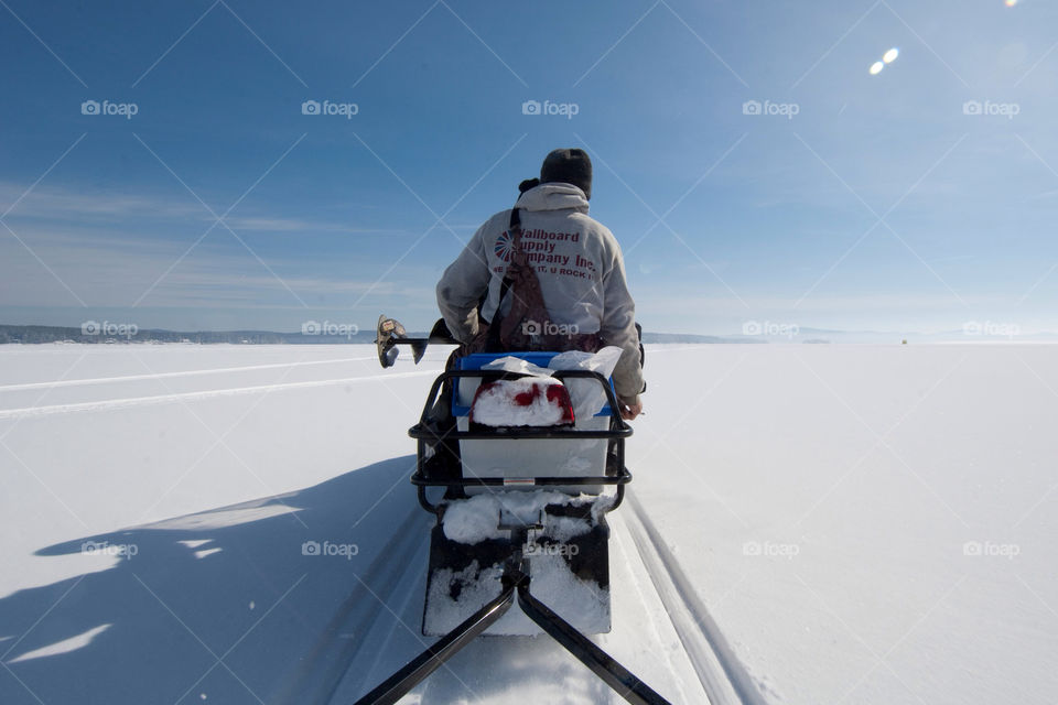 Snowmobiling to my favorite fishing spot on Lake Winnepesaukee