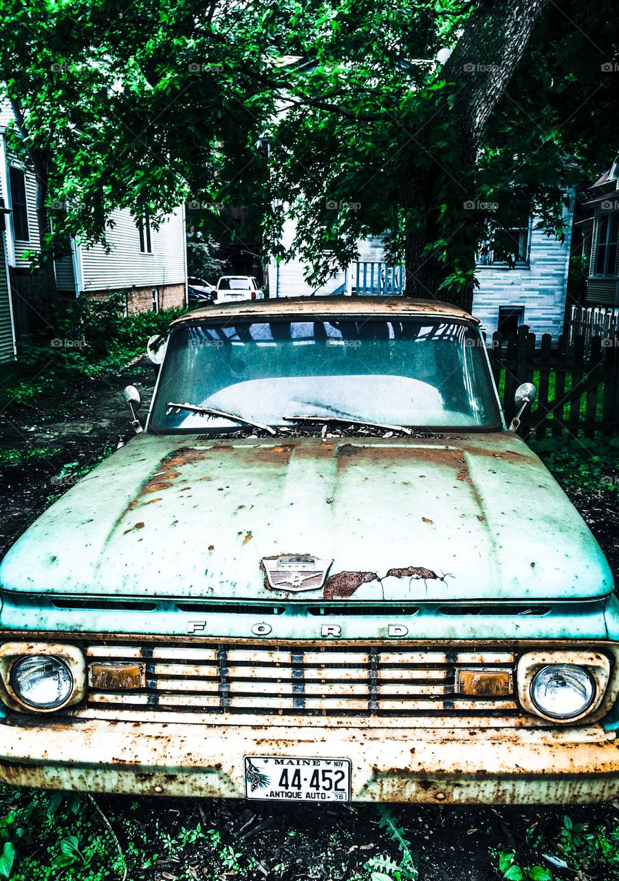 Old Green Ford Truck. Sitting out in the elements slowly fading away. 