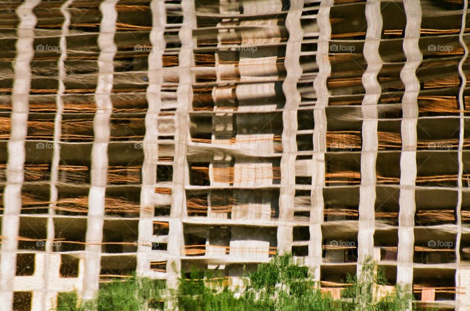 reflection in the lake of an unfinished building