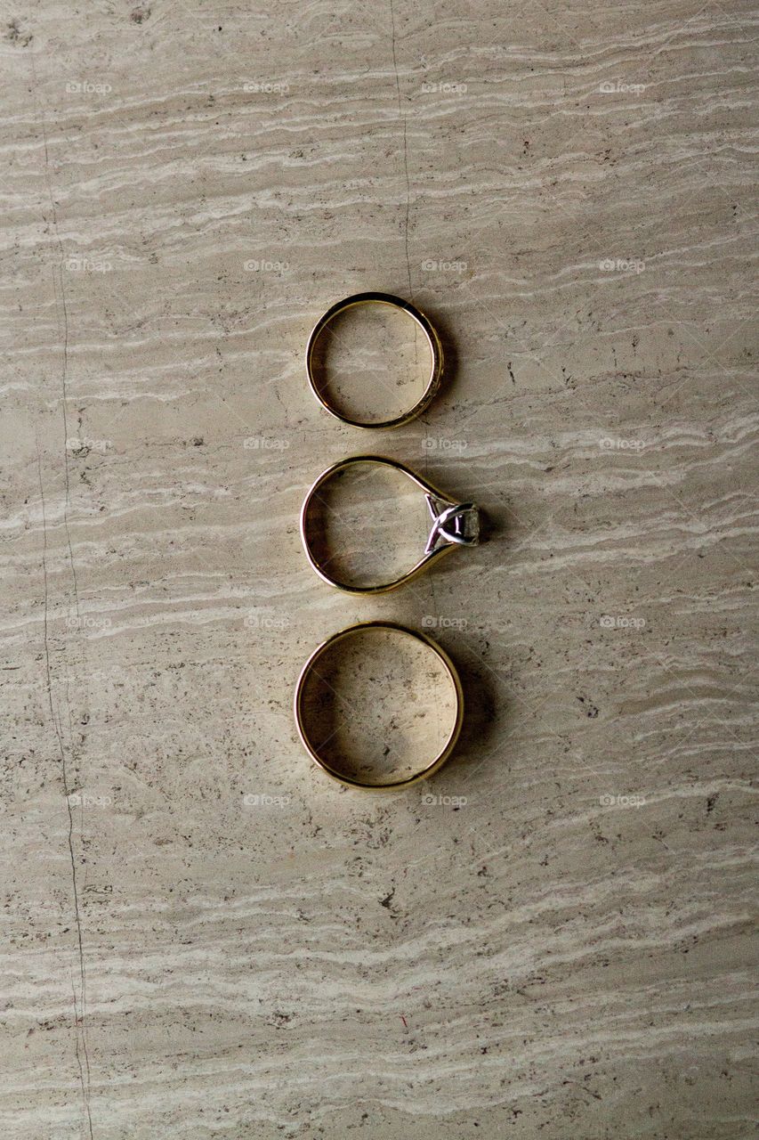 Bride and groom's wedding rings on a marble surface