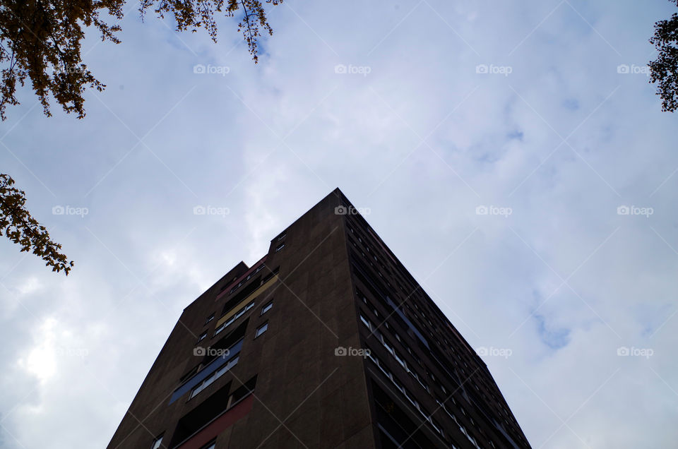 Low angle view of building exterior against cloudy sky in Berlin, Germany.