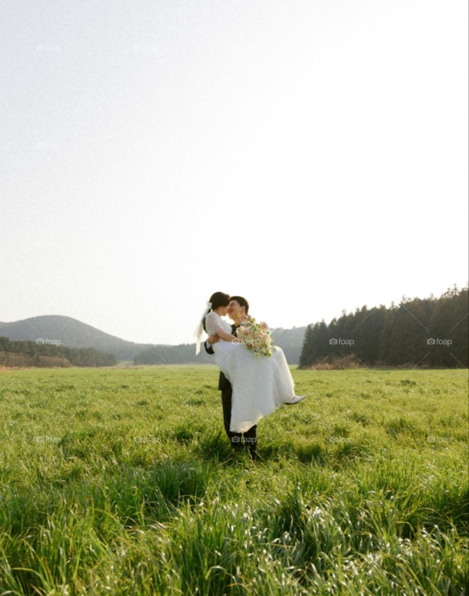 young brides in a field with flowers