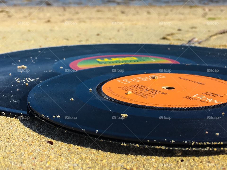 Beach scene vinyl vintage records on beach ocean in sand rainbow on record
