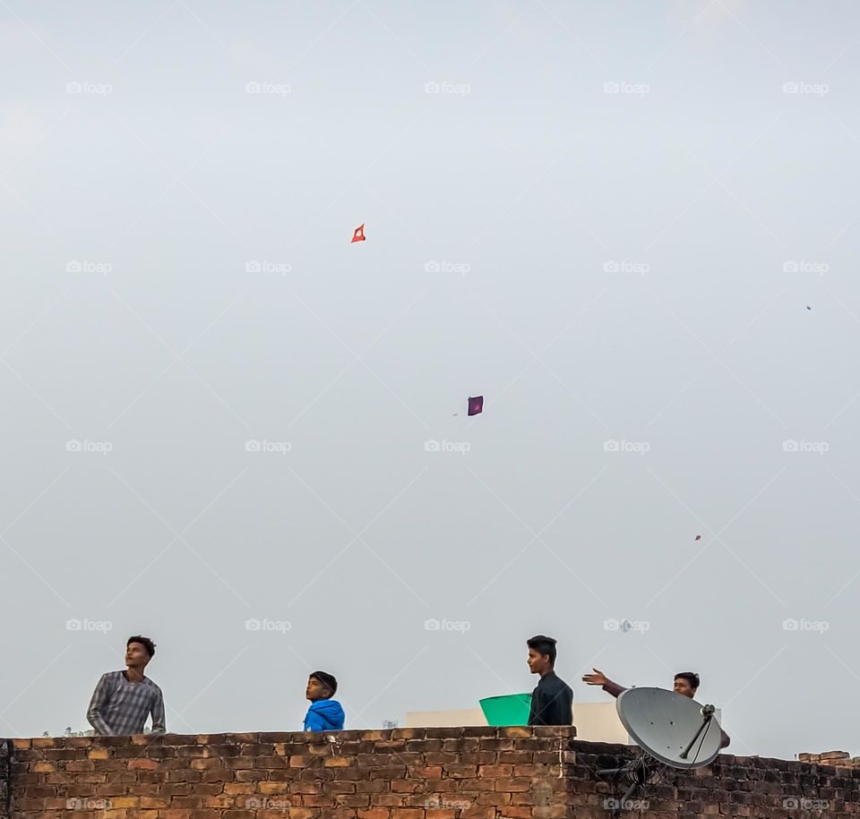 Kids enjoying their childhood by flying kites