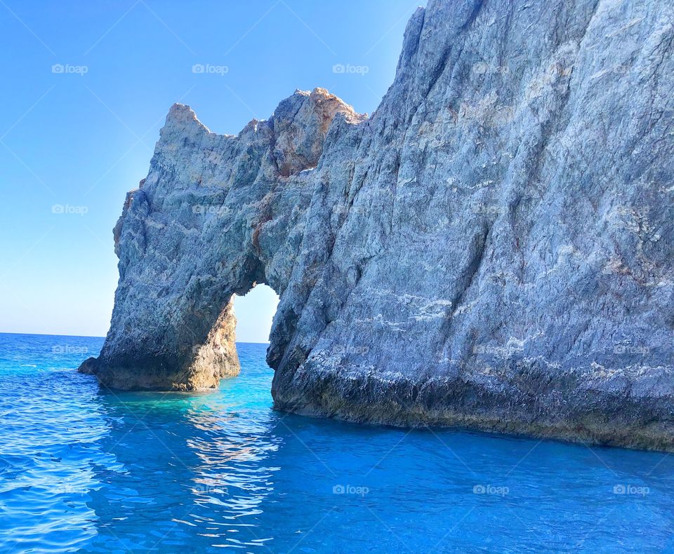 Natural archway, open doorway in the rocks and sea