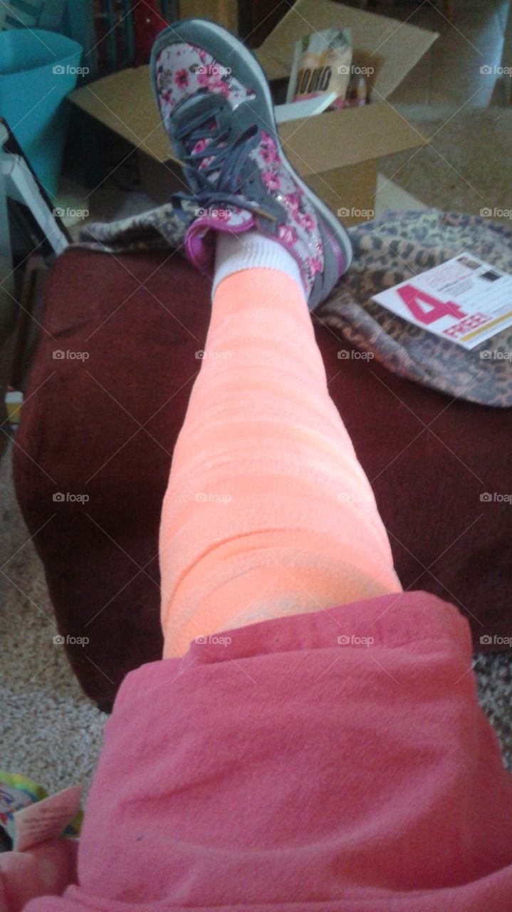 Leg all bandaged up in bright orange.