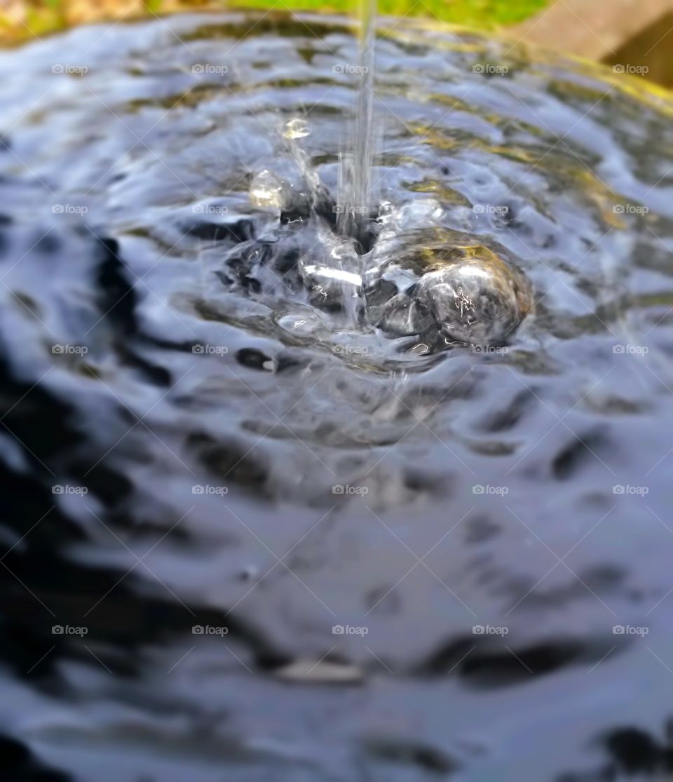 water in motion by a fountain