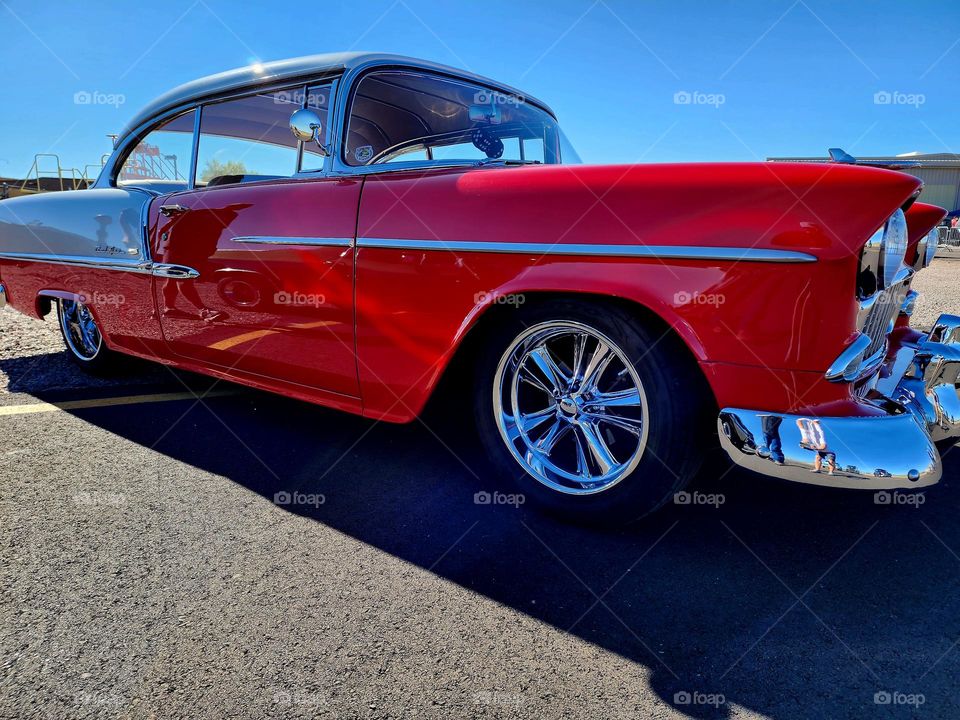 A gorgeous 1955 Chevy hot rod looks splendid in red and white on a flawless fall afternoon