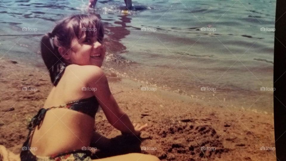 Having fun on the beach building a sandcastle