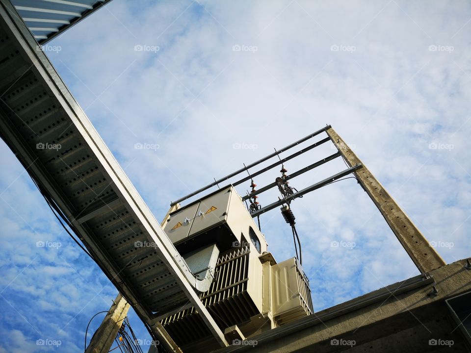 Low angle view of big electric tranformer.