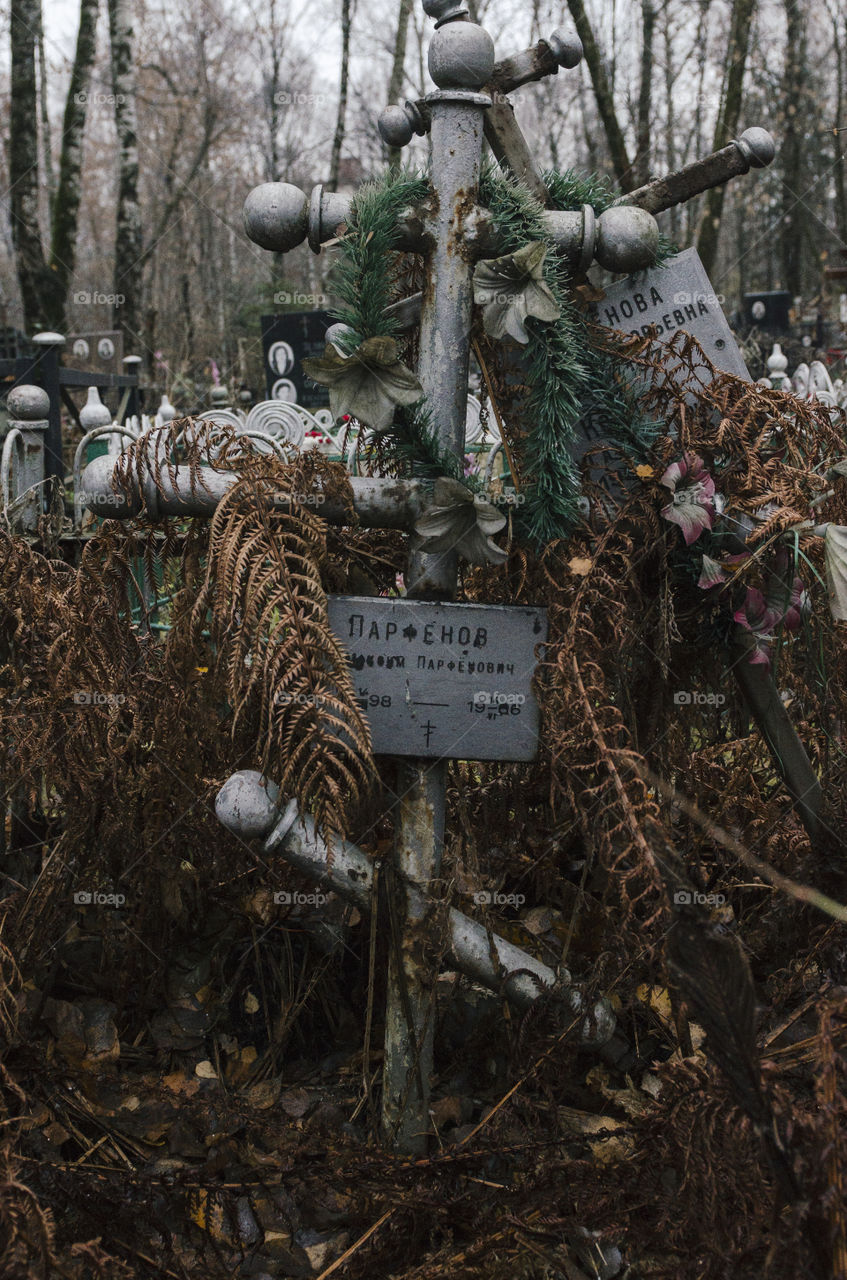 Abandoned grave with shabby crosses 