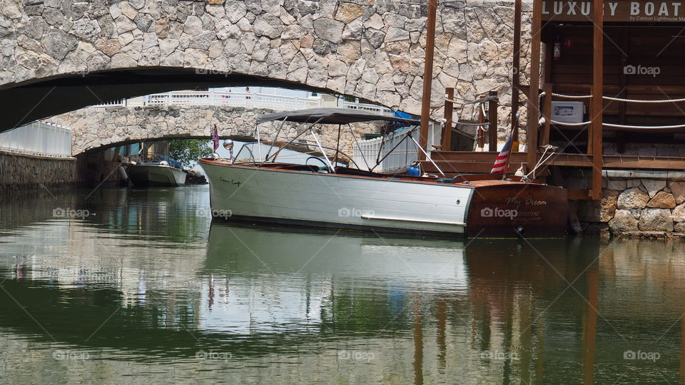 Vintage motorboats at dock. Docked pair of antique vintage luxury motorboats resting