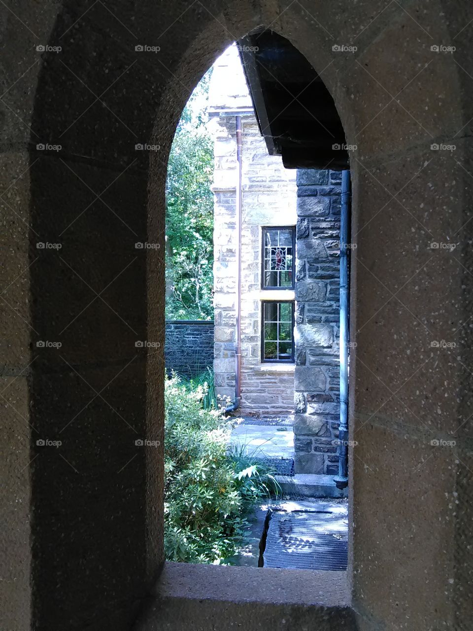 a lovely view from an arched stone window