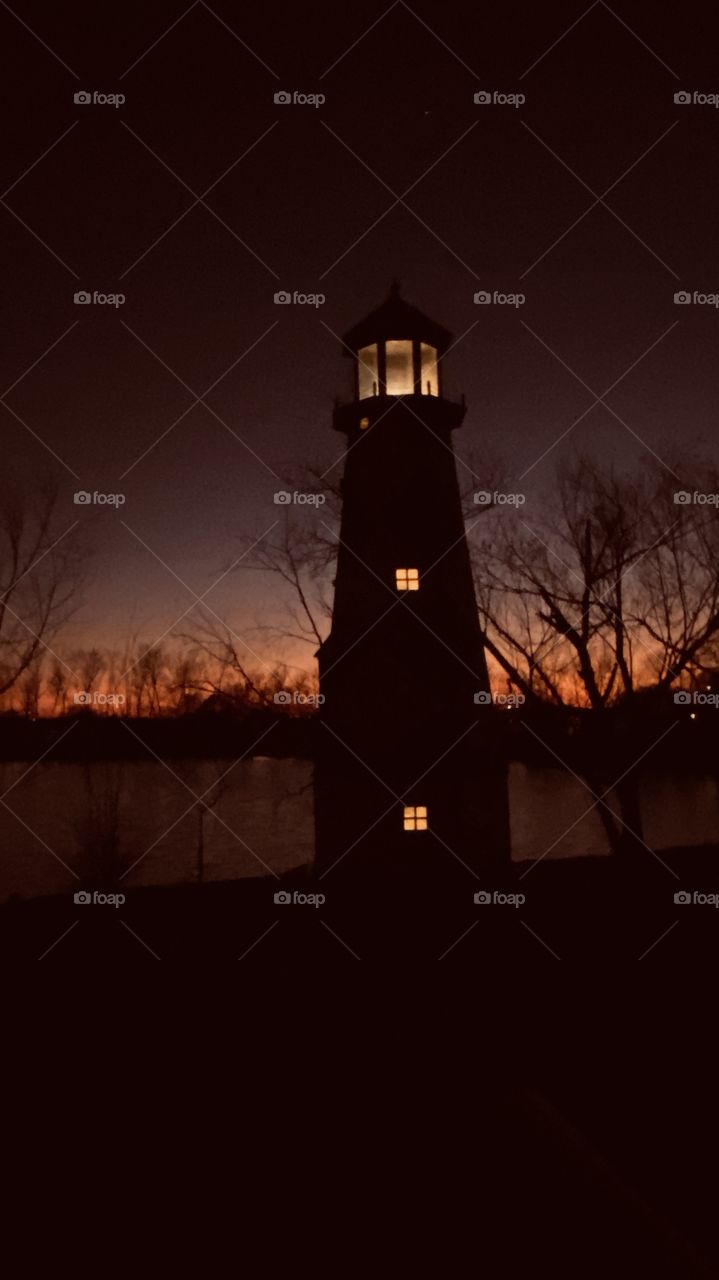 Lighthouse stands Firm providing passage guide light. Sunset-Twilight-Night the Best Part of this Day is now. Nice Backlit Horizon awesome colors making gor s Beautiful Night.