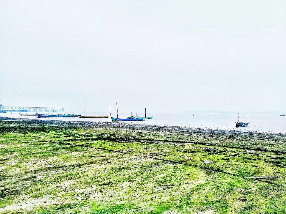 fishing boat.the fisherman are leaning on the beach