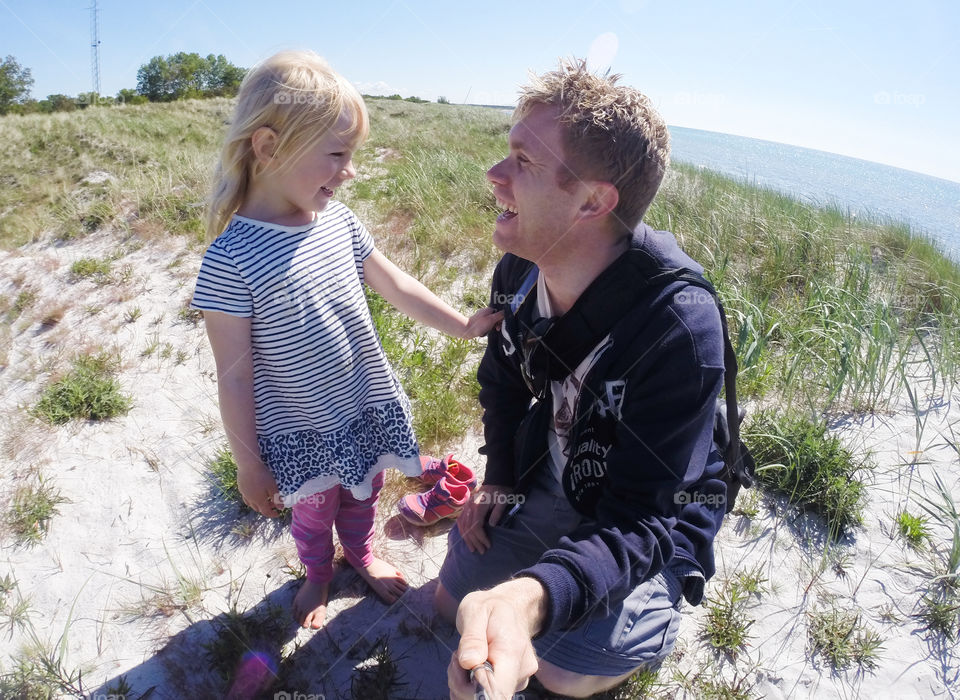 Dad and doughter having fun at the beach.