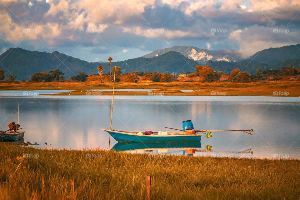 A boat parked by the river bank for transportation and fishing 