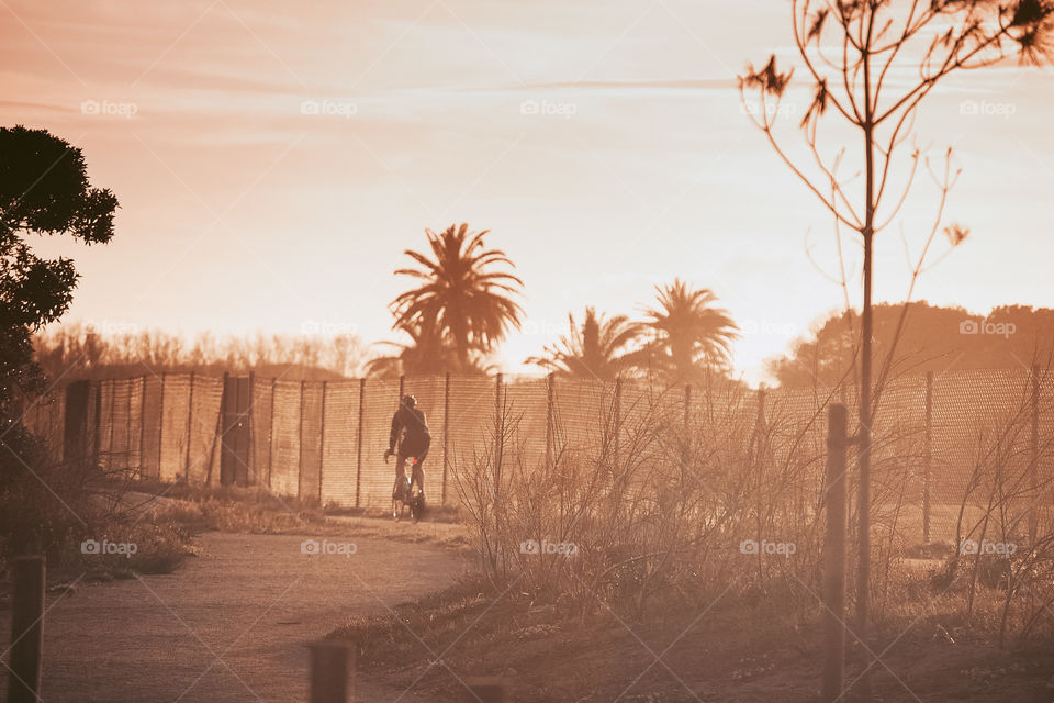 Photo of a cyclist during sunset 