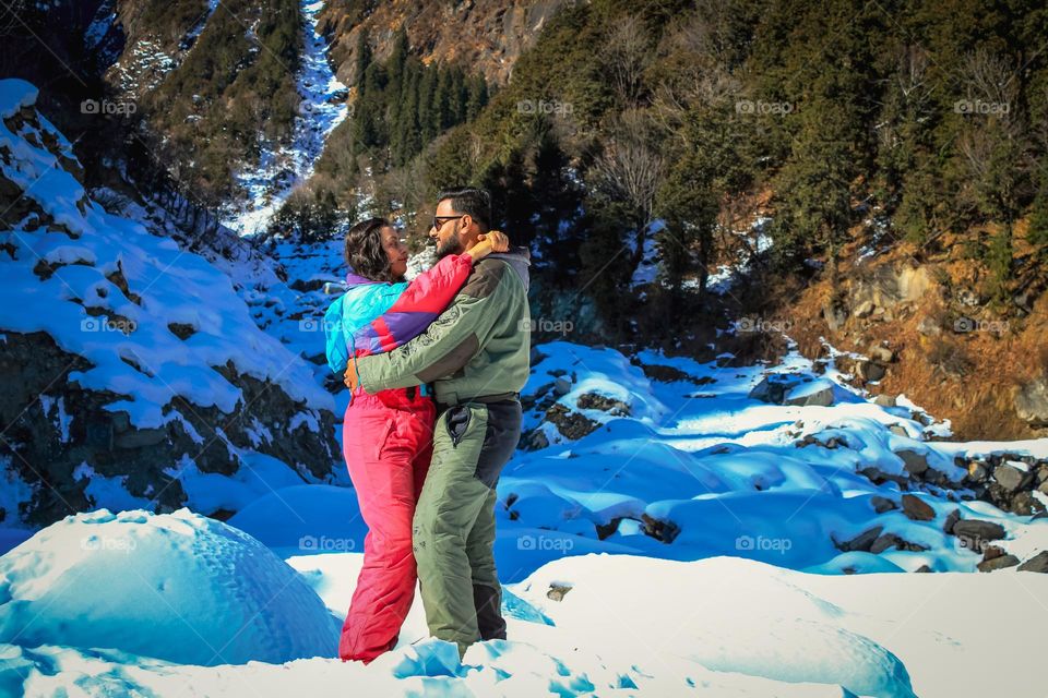 Romantic couple loving each other on a chilled snow