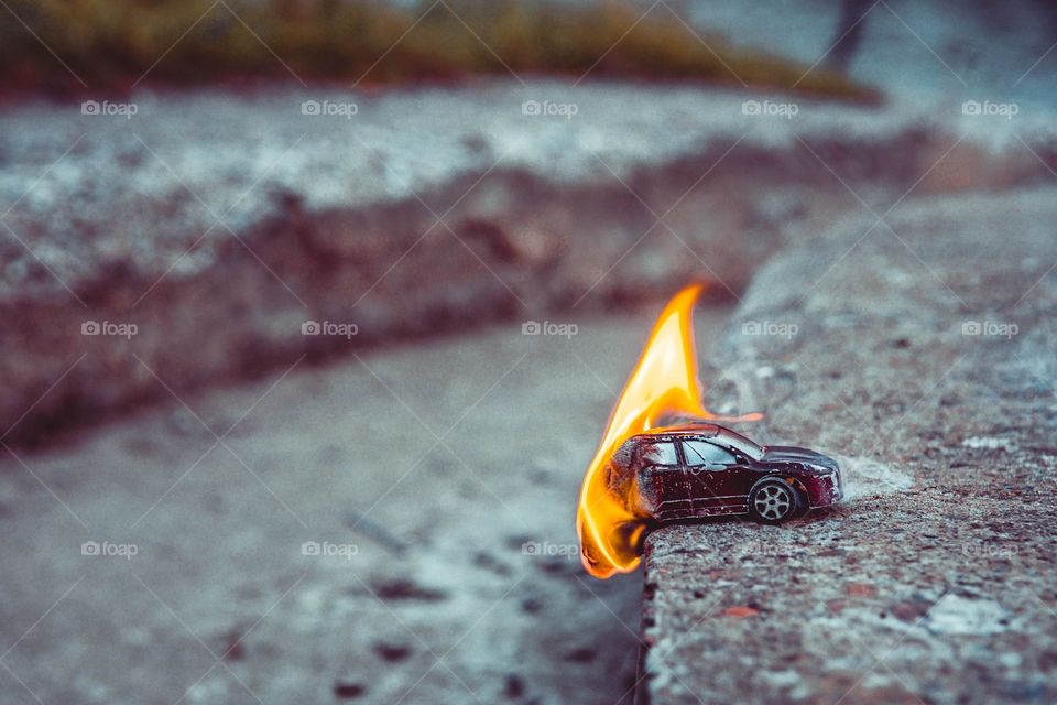 Close up photo of burning toy car