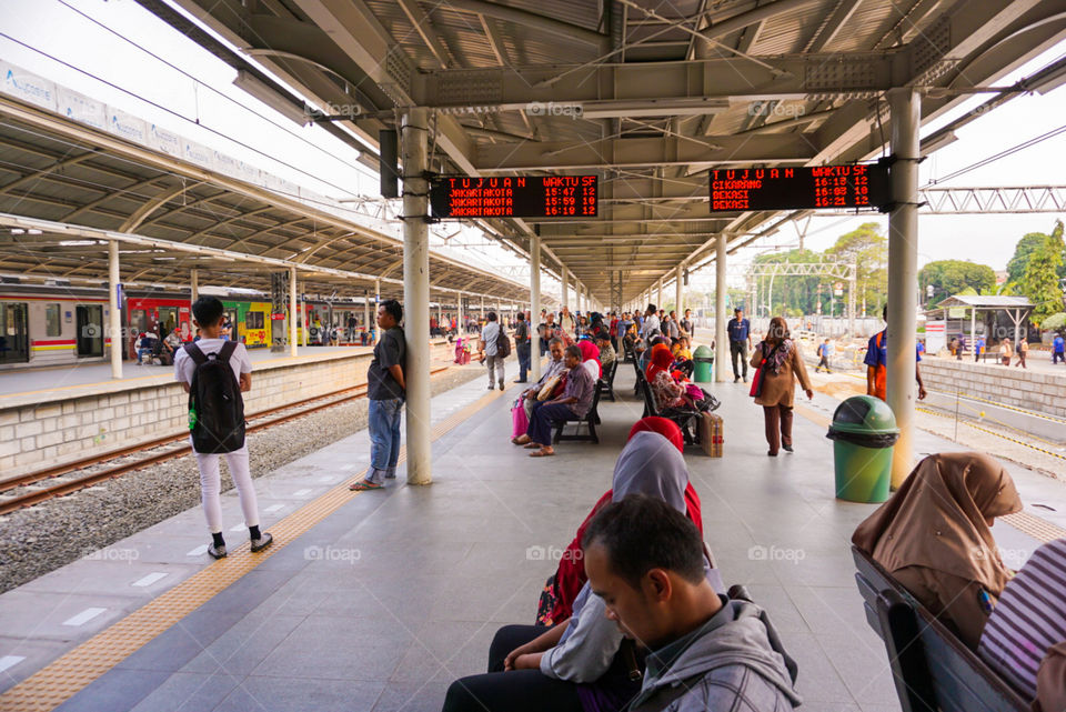 This photo was taken at the Jatinegara station, Jakarta, Indonesia. One of the big busy transit stations in Jakarta. All the crowds are gathering here for their own purposes. Here everyone is waiting for their destination trains. In their own way