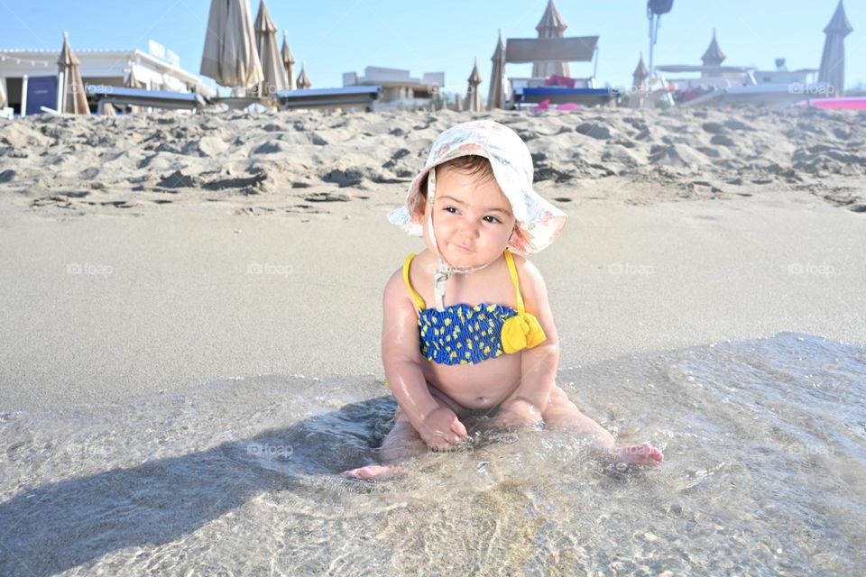 little girl playing in the sea