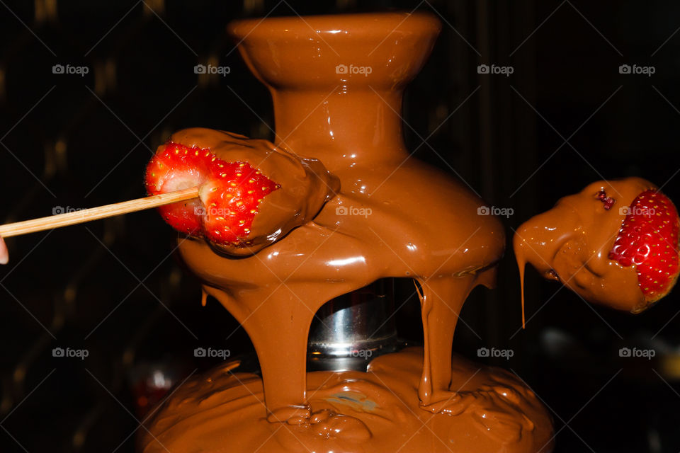 Strawberries in choc fountain 