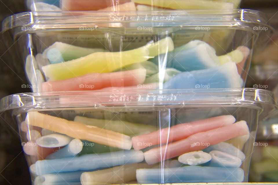 Wax Bottles Filled with Sweet Juice in Stacked Plastic Containers