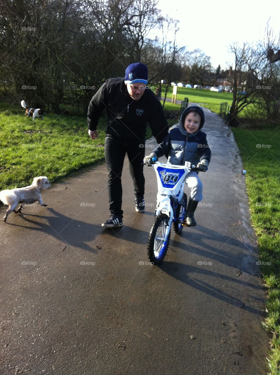 Father helping his son riding bicycle