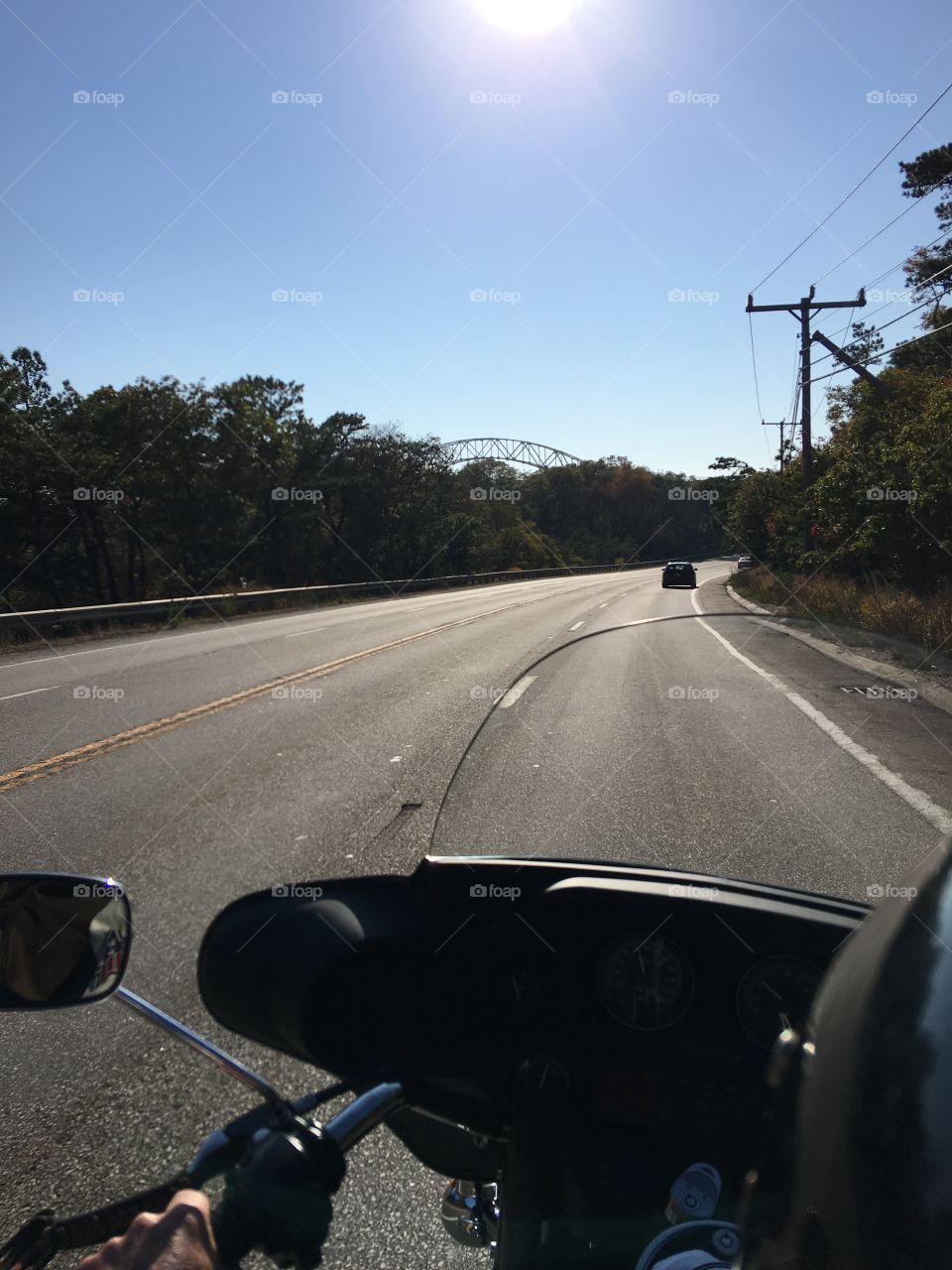 View looking at Bourne Bridge riding Harley Davidson along Cape Cod Canal highway. 🏍 Sunny day bikers love!