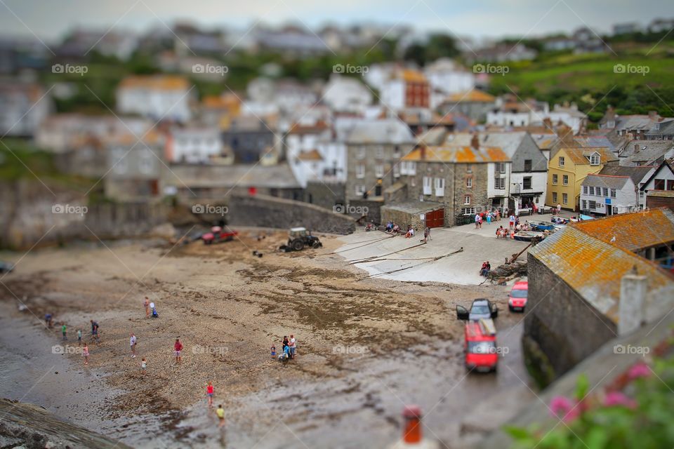 Seaside Harbour In Miniature. A birds eye view of a fishing village and beach with a miniature feel.