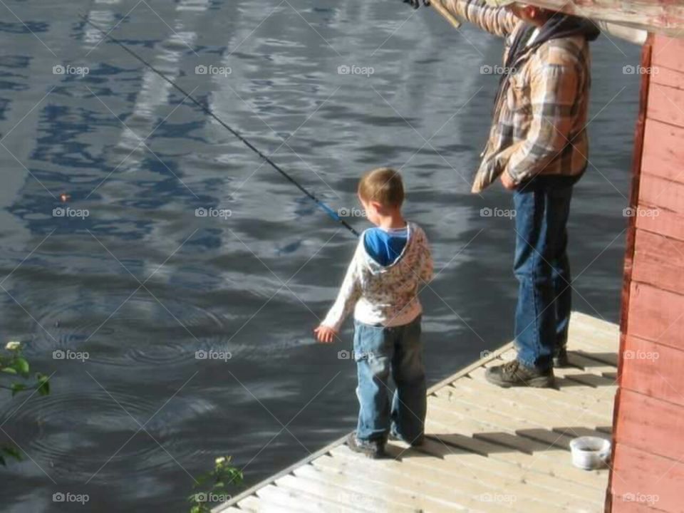 Learning to cast fish off the dock with Dad.