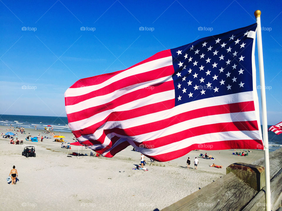 An American Flag blows in the win at Folly Beach on Memorial Day weekend. 