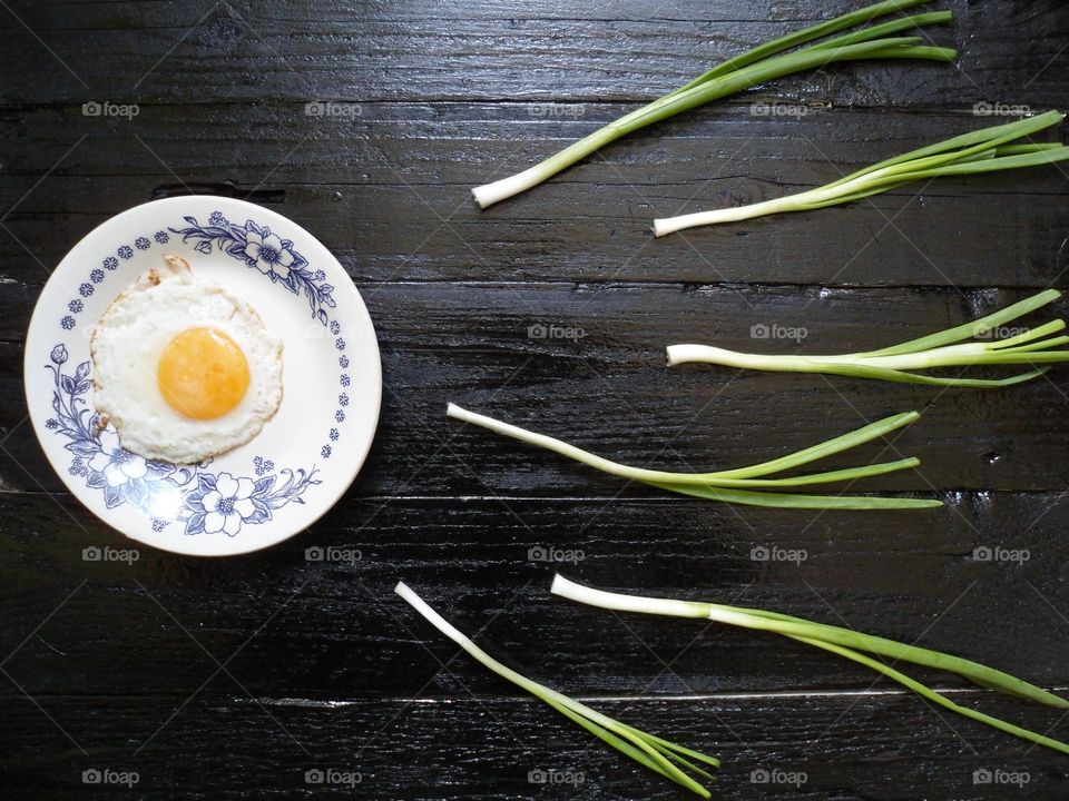 scrambled eggs and onions on a black background