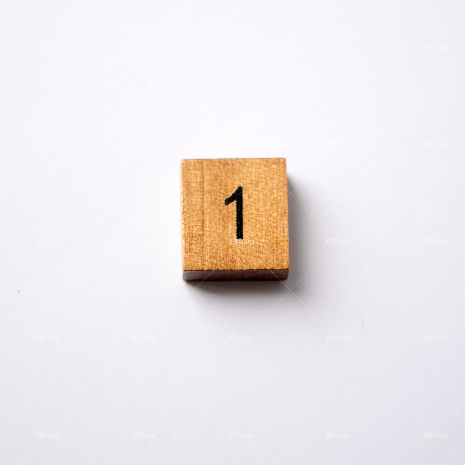 Wooden block Number one on white background