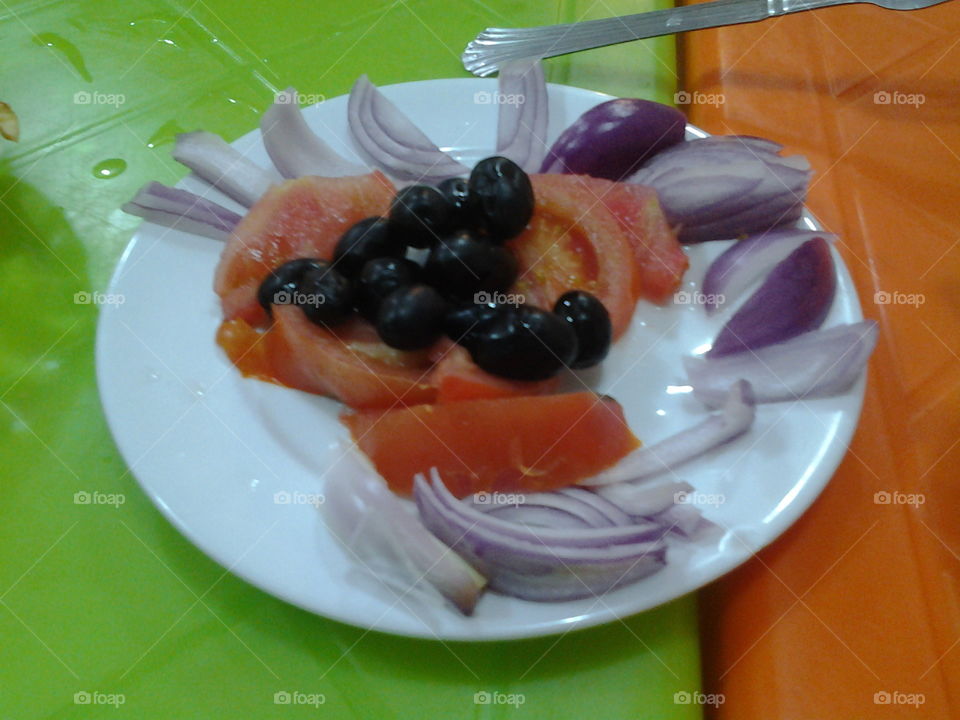 Salad - Slices of onion, tomates and black olives