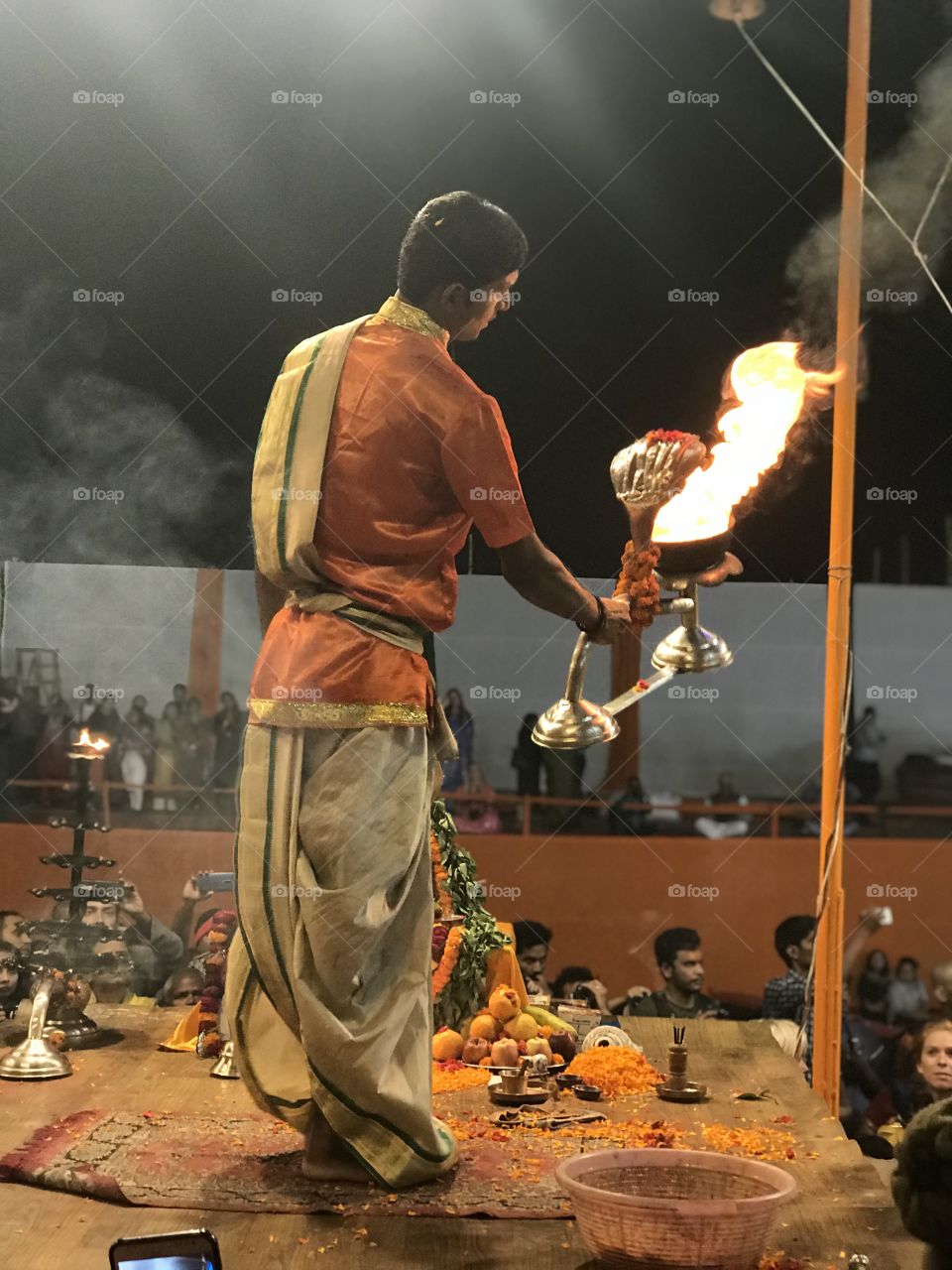 Performing Aarti; offering lamps at Varanasi. 