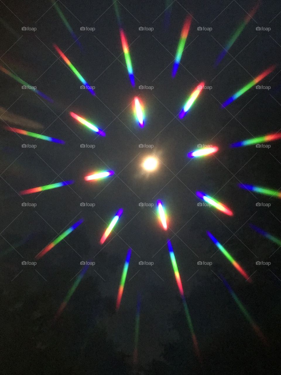 June 24, 2018 Moon beams as seen through a 3D lens. Shine on mighty moon. That is the moon in the center of the lights 