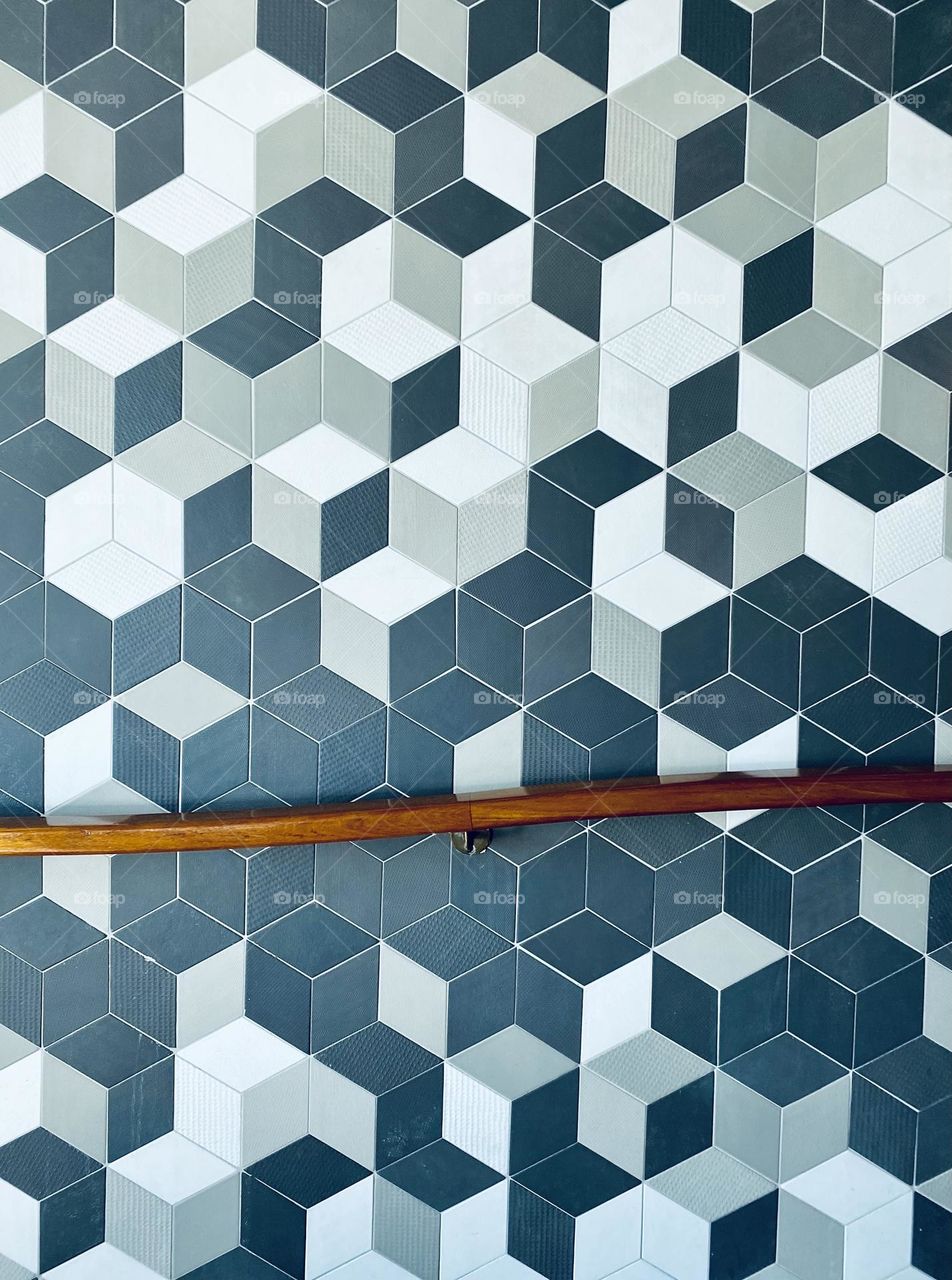 Wall tiles and a wooden hand rail 
