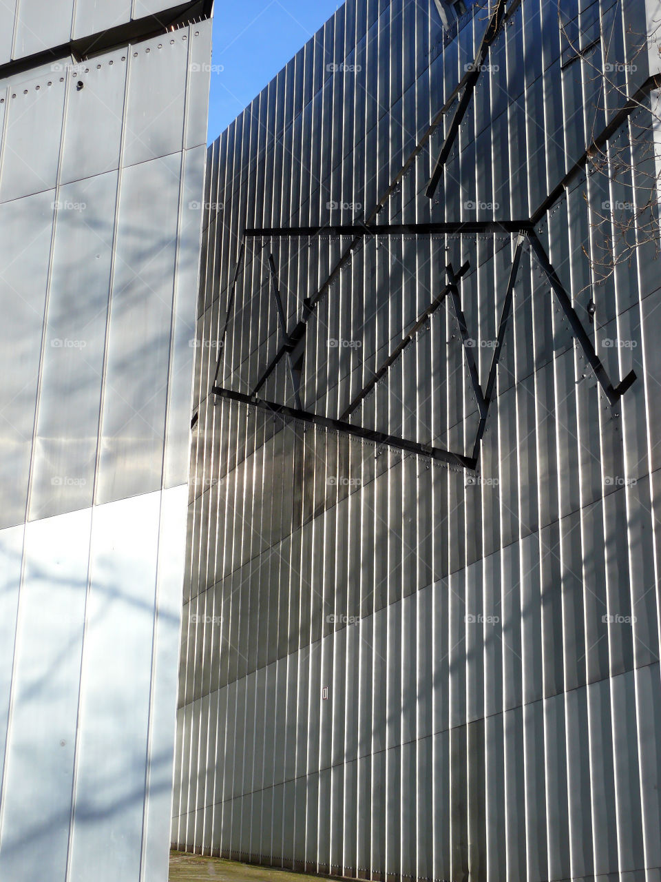 Low angle view of built structure of the Jewish Museum Berlin against clear sky.