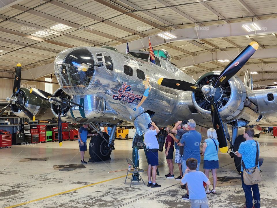 People line up to climb through a World War II era Boeing B-17G bomber that is still flight worthy