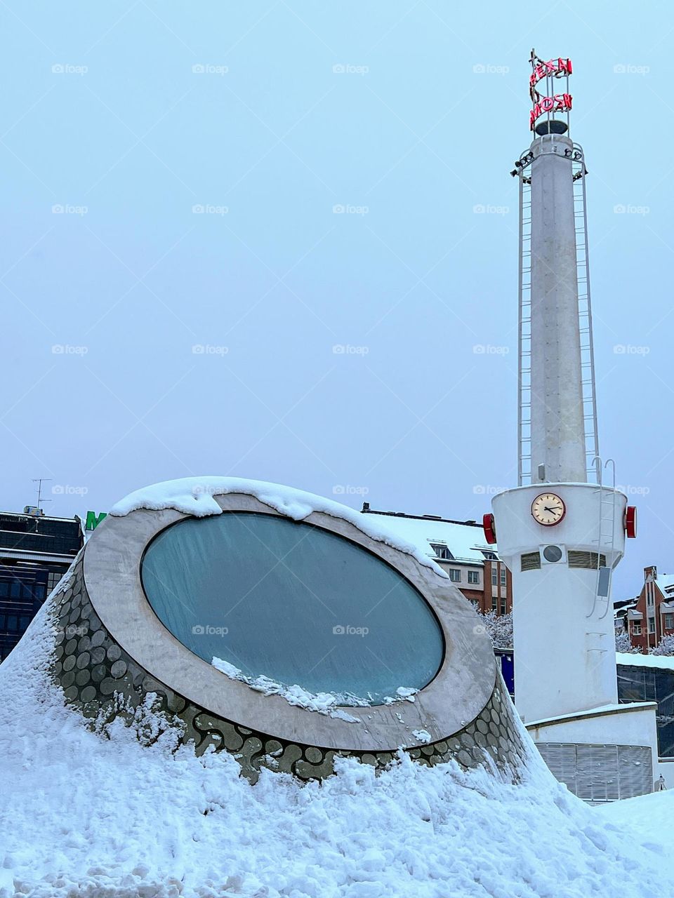 Futuristic abstract shape form of modern art underground museum roof window and tall pillar with red sign and clock