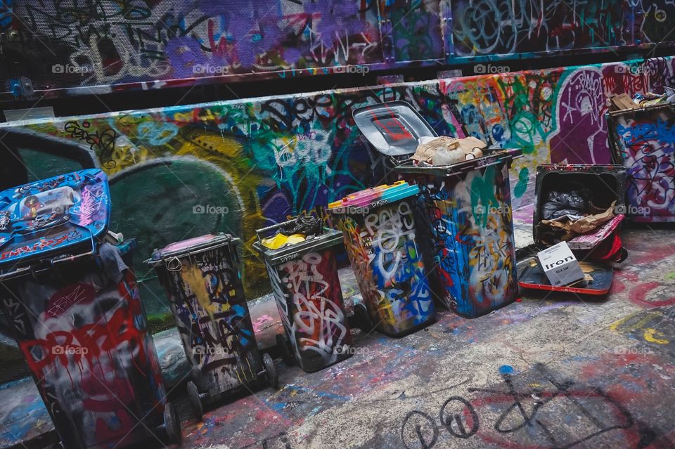 Graffitied bins/garbage/trash cans on Hosier Lane in Melbourne, Australia. This is a designated area in the city for people to come and display their street art.