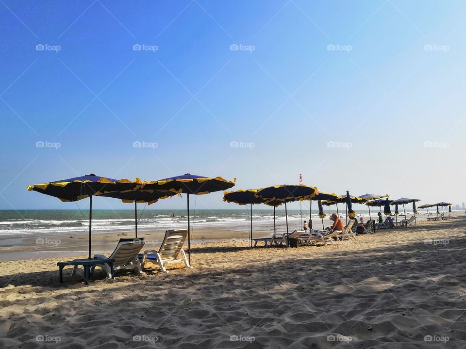 Beds with umbrellas on a Thai beach